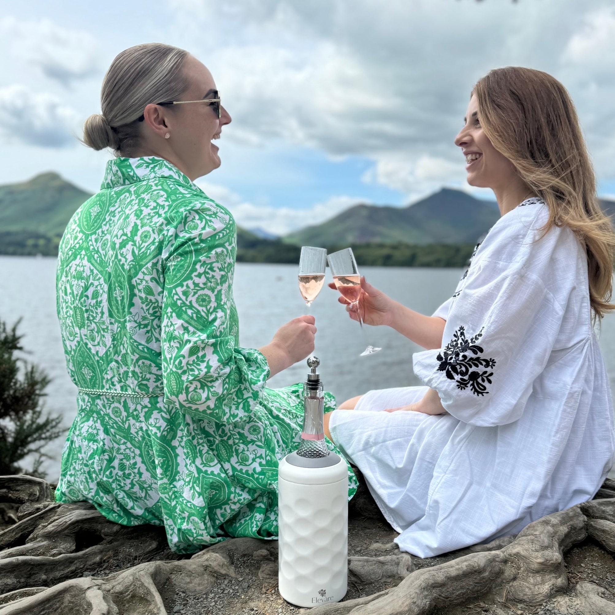 2 females over looking the lake saying cheers